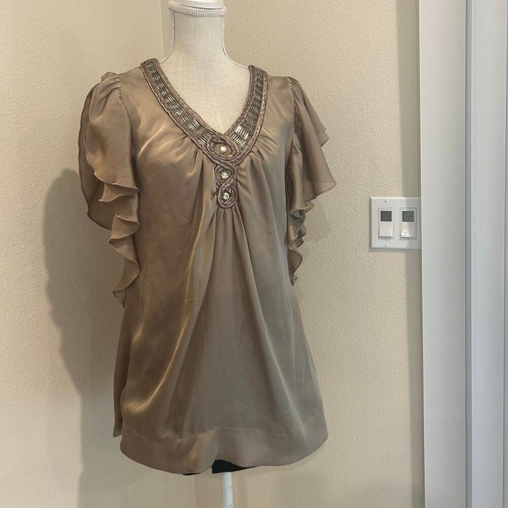 Piano tan blouse with ruffle sleeves and beaded details. Size XL